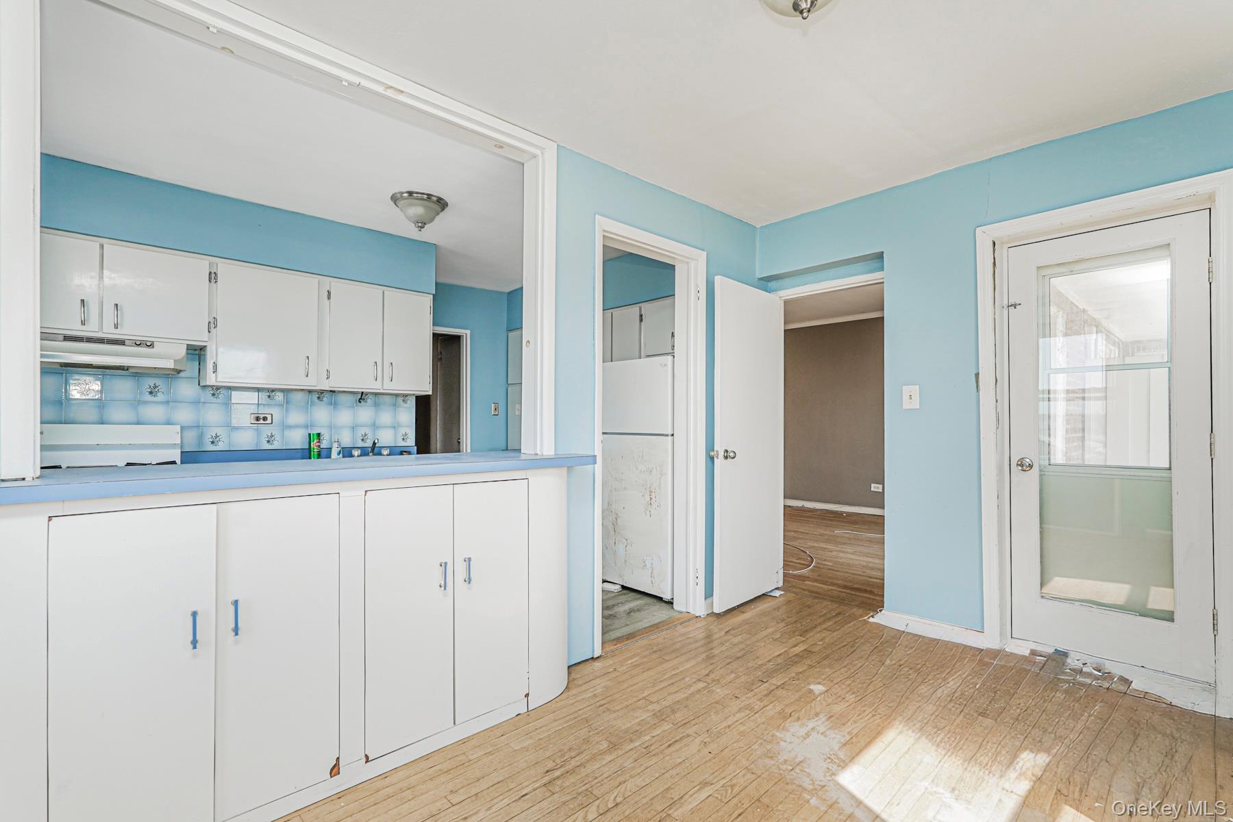 125 Beach 124th Street, Unit 6H Queens, NY 11694 - Photo 12 of 27 a kitchen with granite countertop white cabinets and refrigerator