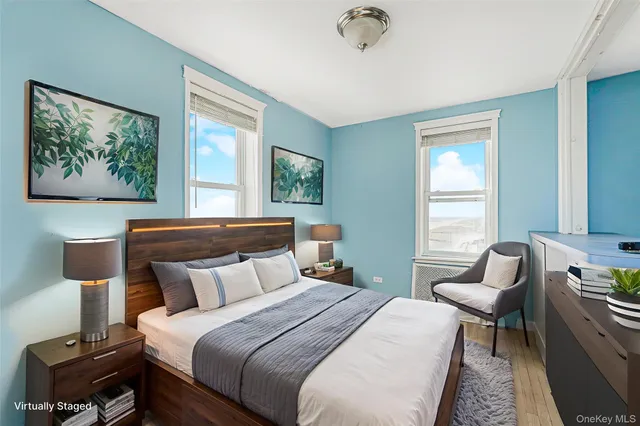 a bedroom with a bed a couch and windows