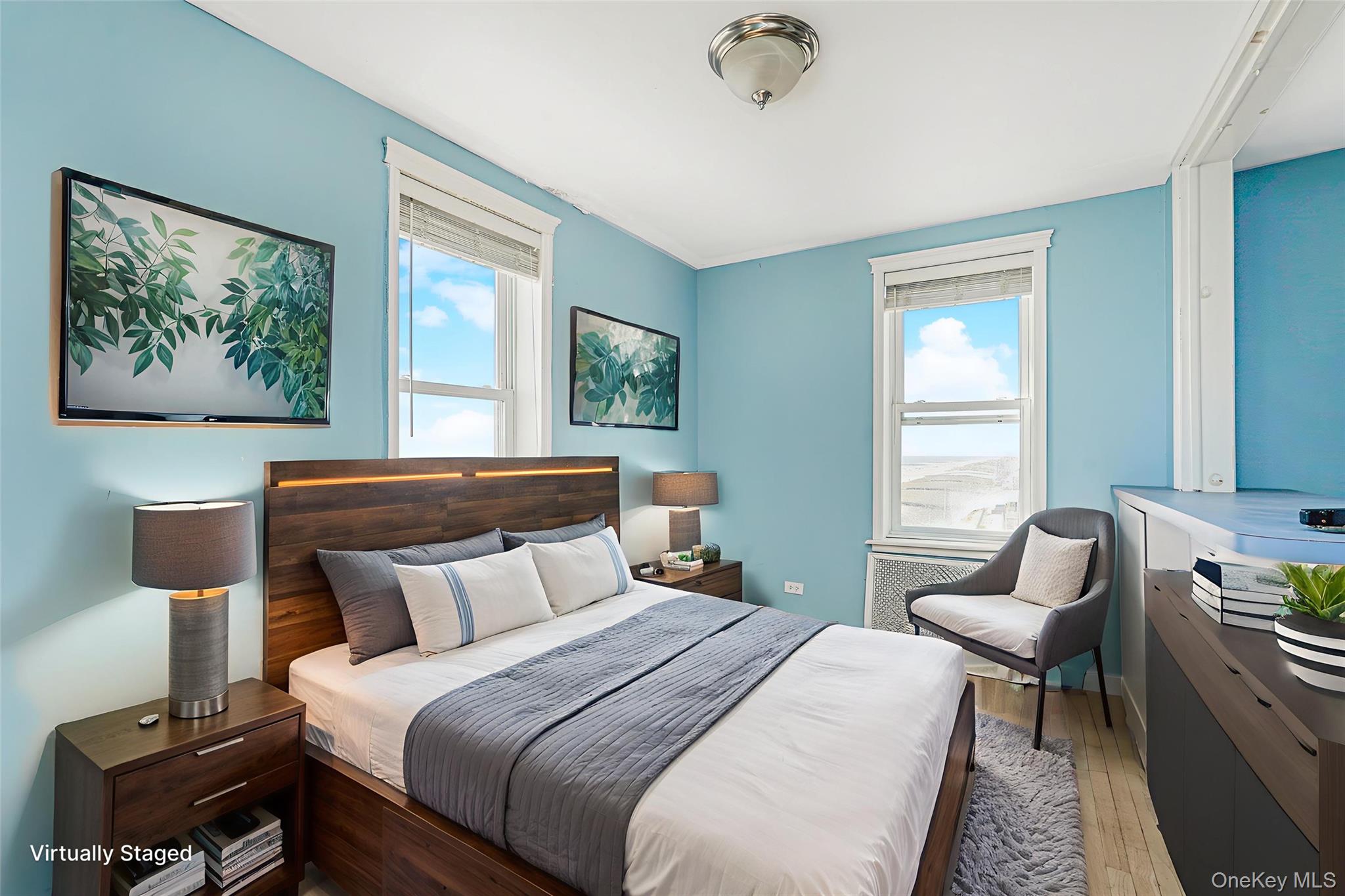 125 Beach 124th Street, Unit 6H Queens, NY 11694 - Photo 15 of 27 a bedroom with a bed a couch and windows