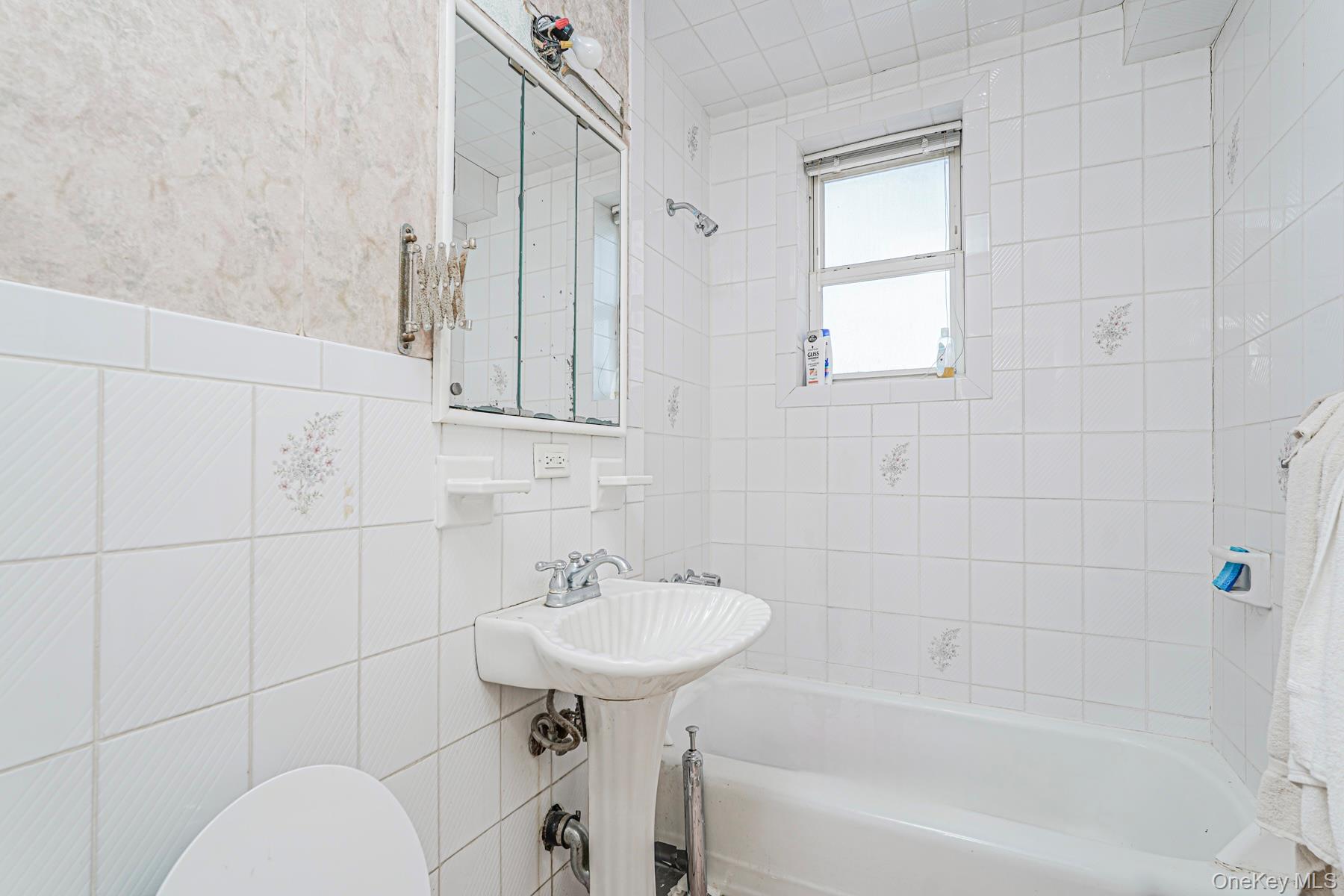 125 Beach 124th Street, Unit 6H Queens, NY 11694 - Photo 16 of 27 a bathroom with a sink toilet and shower