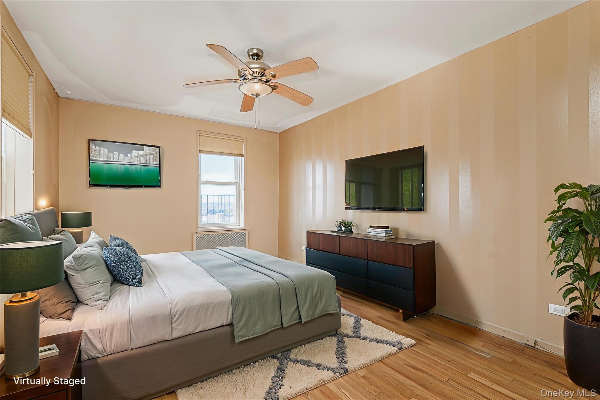 125 Beach 124th Street, Unit 6H Queens, NY 11694 - Photo 18 of 27 a bedroom with a bed and a flat screen tv