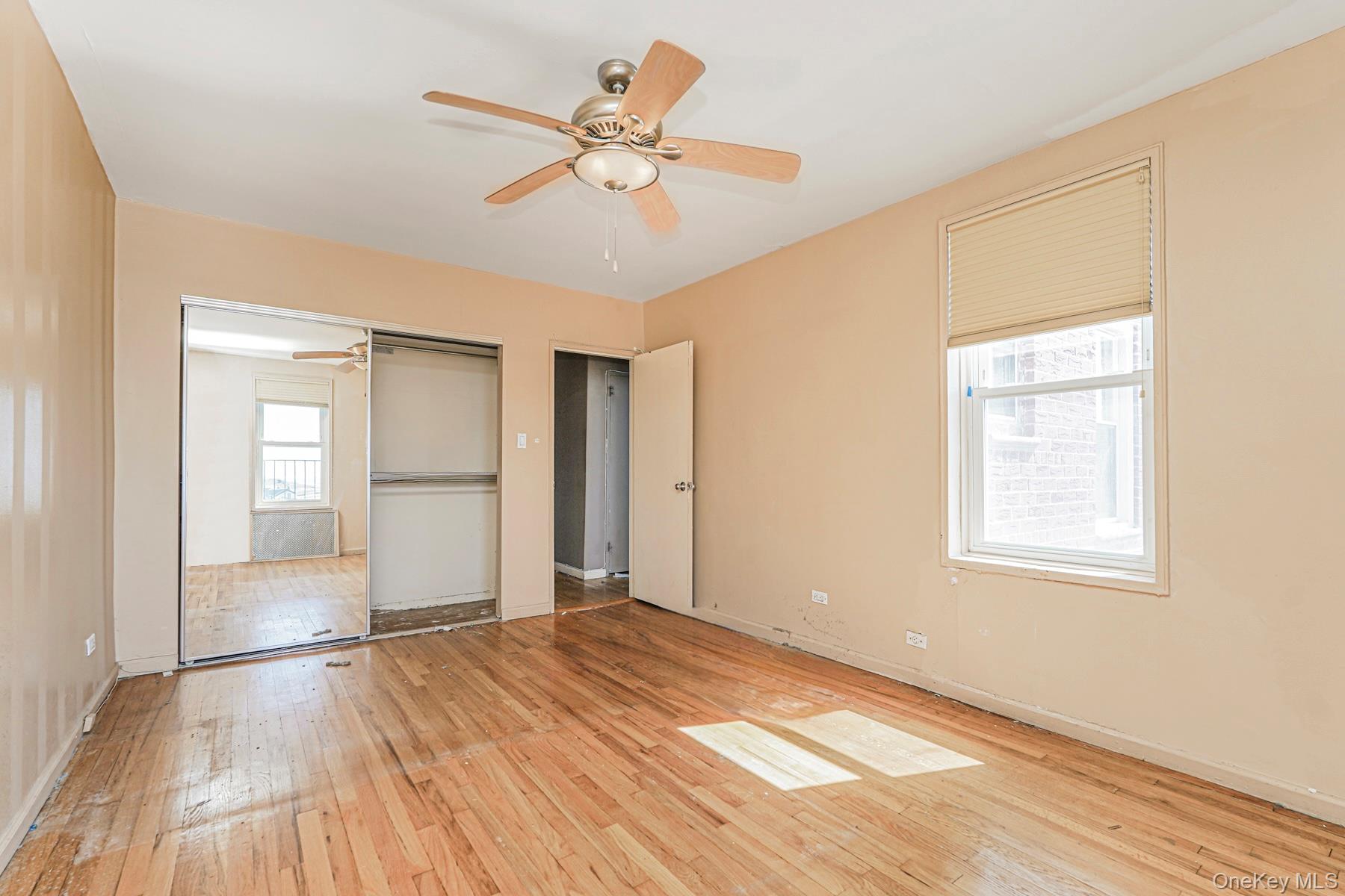 125 Beach 124th Street, Unit 6H Queens, NY 11694 - Photo 19 of 27 a view of empty room with wooden floor and fan
