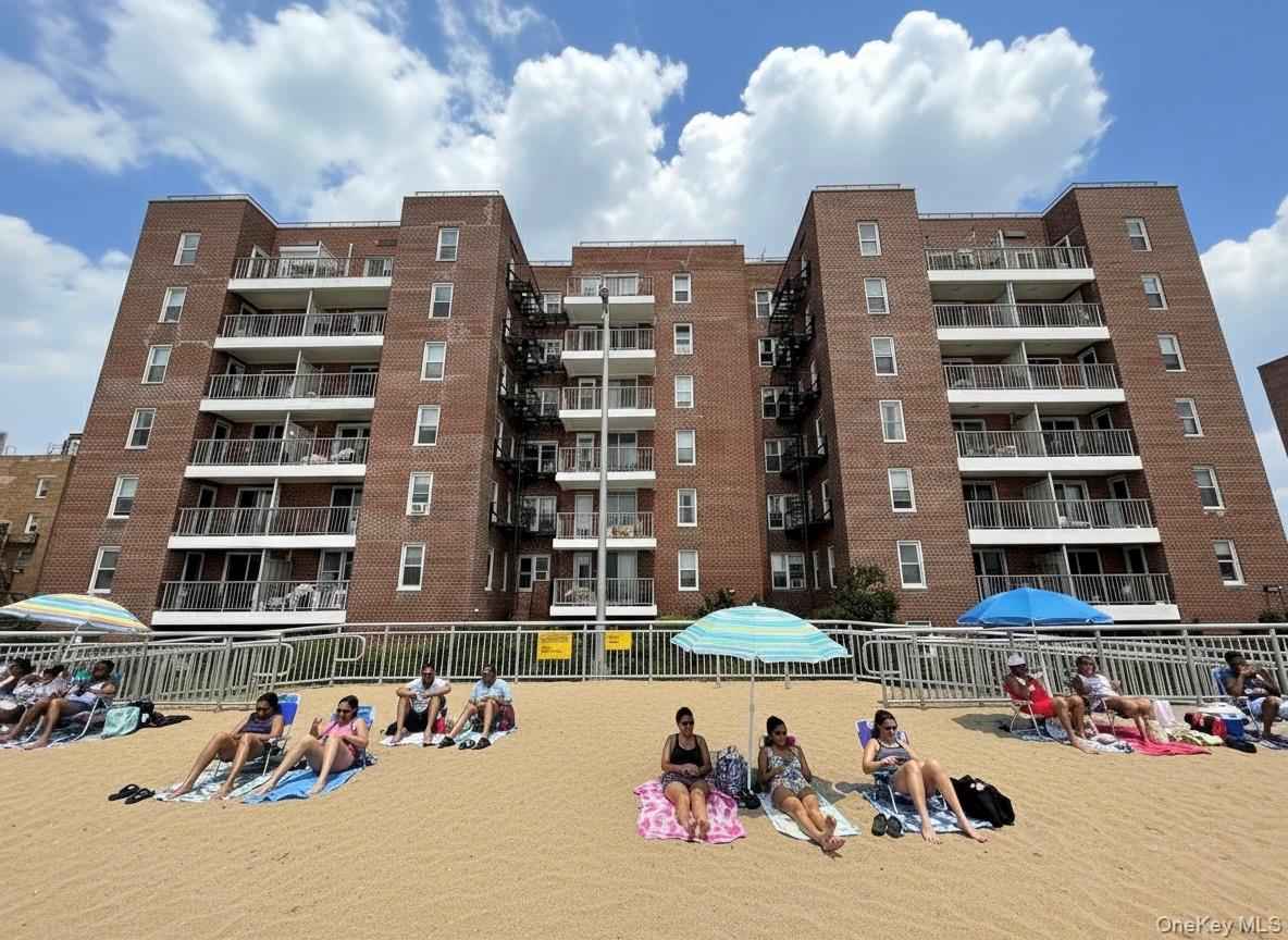 125 Beach 124th Street, Unit 6H Queens, NY 11694 - Photo 23 of 27 a front view of a building with streets and trees