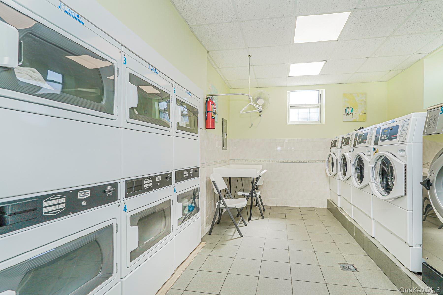 125 Beach 124th Street, Unit 6H Queens, NY 11694 - Photo 25 of 27 a kitchen with stainless steel appliances granite countertop a white cabinets and white appliances