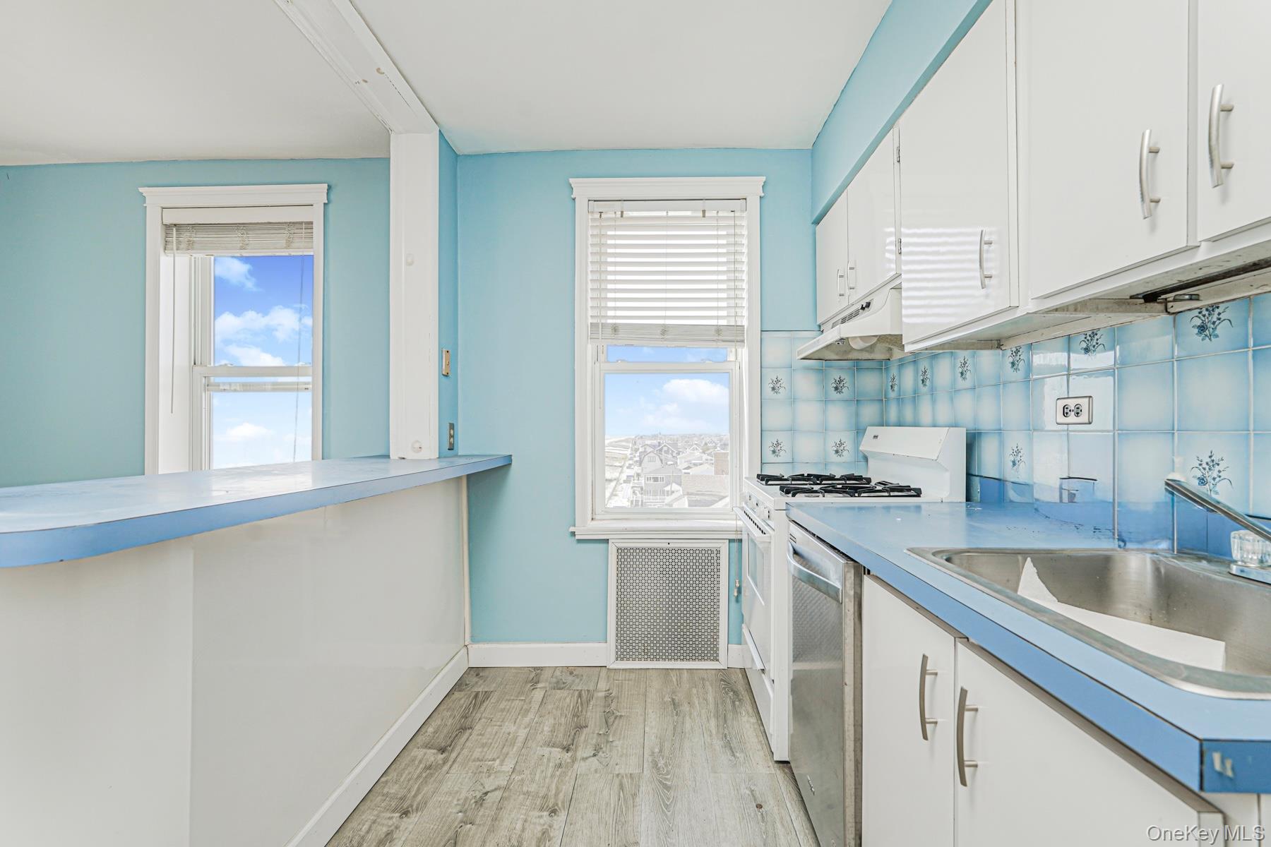125 Beach 124th Street, Unit 6H Queens, NY 11694 - Photo 8 of 27 a kitchen with granite countertop a sink a counter space appliances and cabinets