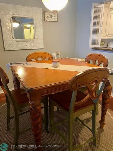 a view of a dining room with furniture and window