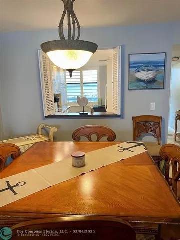 a room with pool table and windows