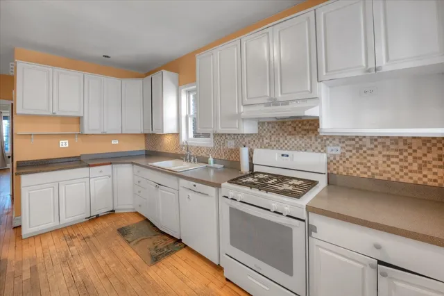 a kitchen with sink and cabinets