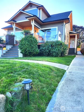 a front view of a house with a yard table and chairs