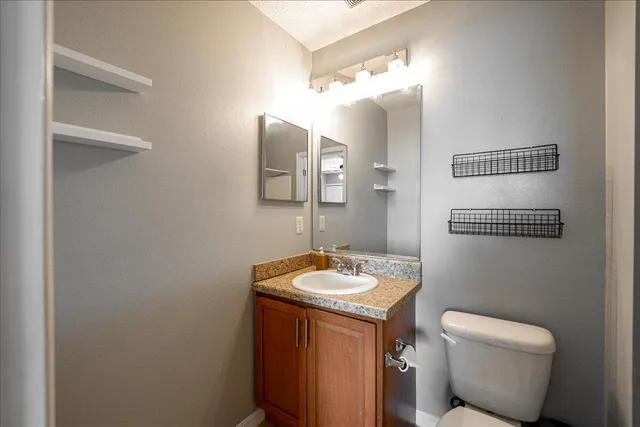 a bedroom with a bed a couch and dresser