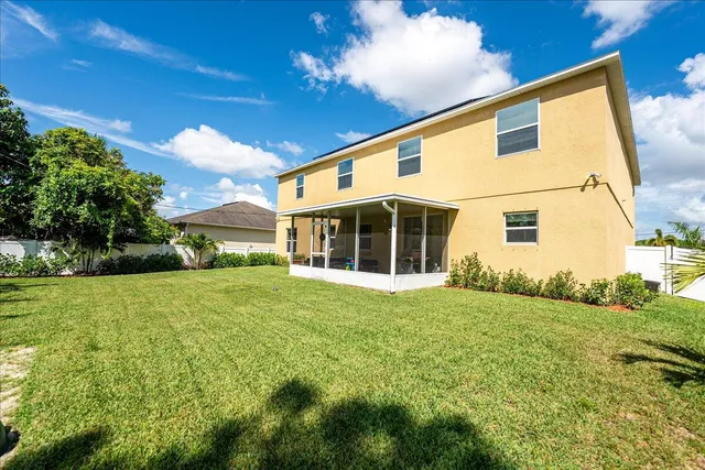 a view of a backyard with potted plants