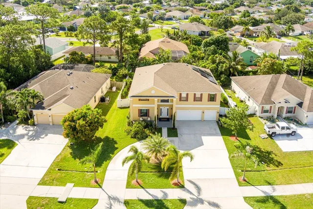 an aerial view of a house with a yard