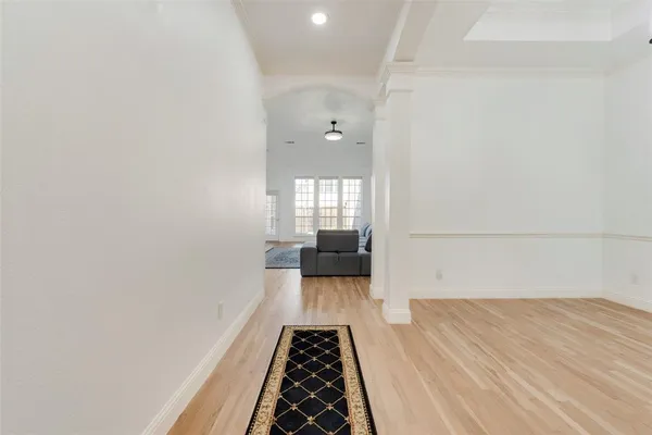 a view of a room with wooden floor
