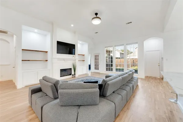 a living room with furniture a fireplace and a flat screen tv