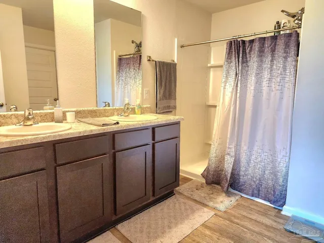 a bathroom with a double vanity sink and a mirror