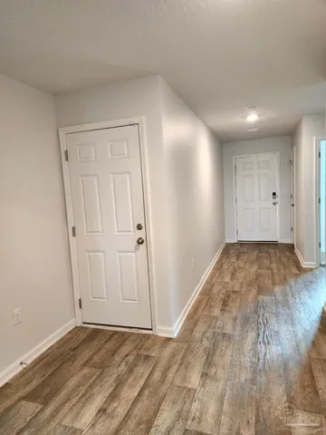 a view of a room with wooden floor
