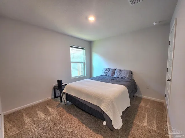 a bedroom with a bed and window