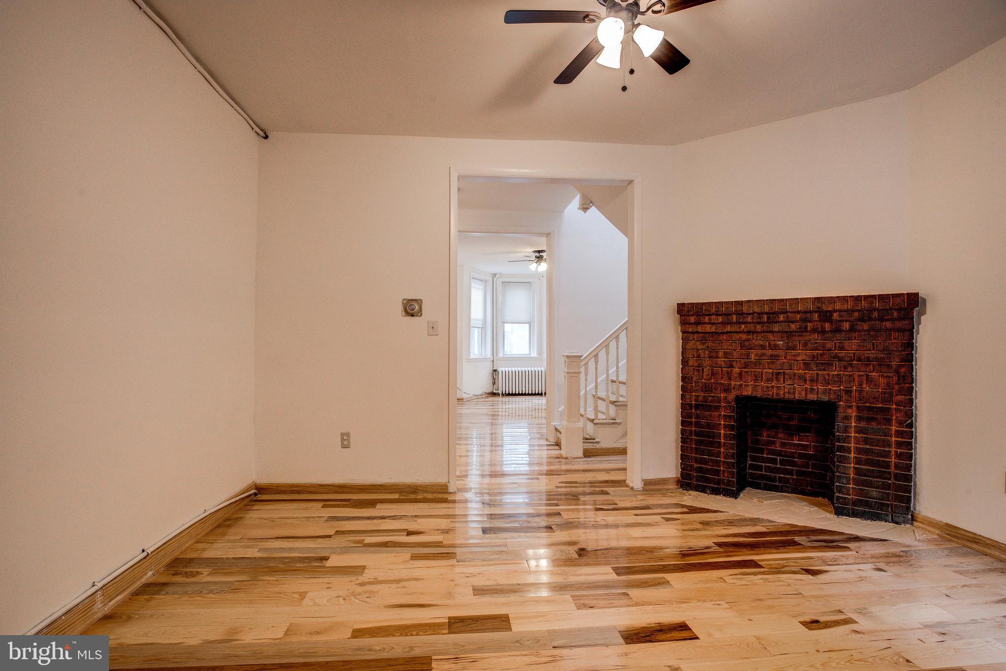 1528 E Street Southeast Washington, DC 20003 - Photo 13 of 30 a view of empty room with fireplace and fan
