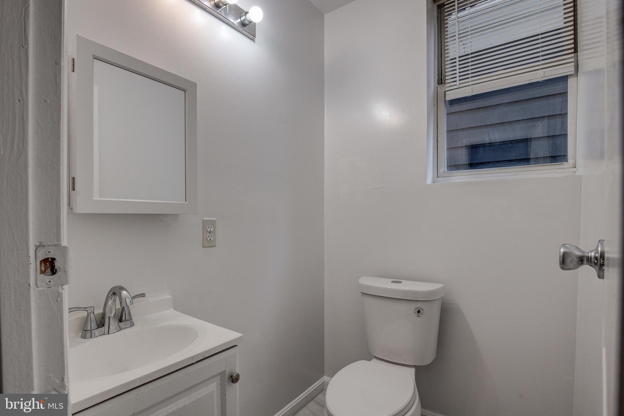 1528 E Street Southeast Washington, DC 20003 - Photo 16 of 30 a bathroom with a toilet sink and mirror