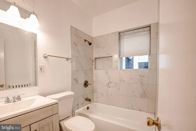 a bathroom with a sink toilet tub and shower