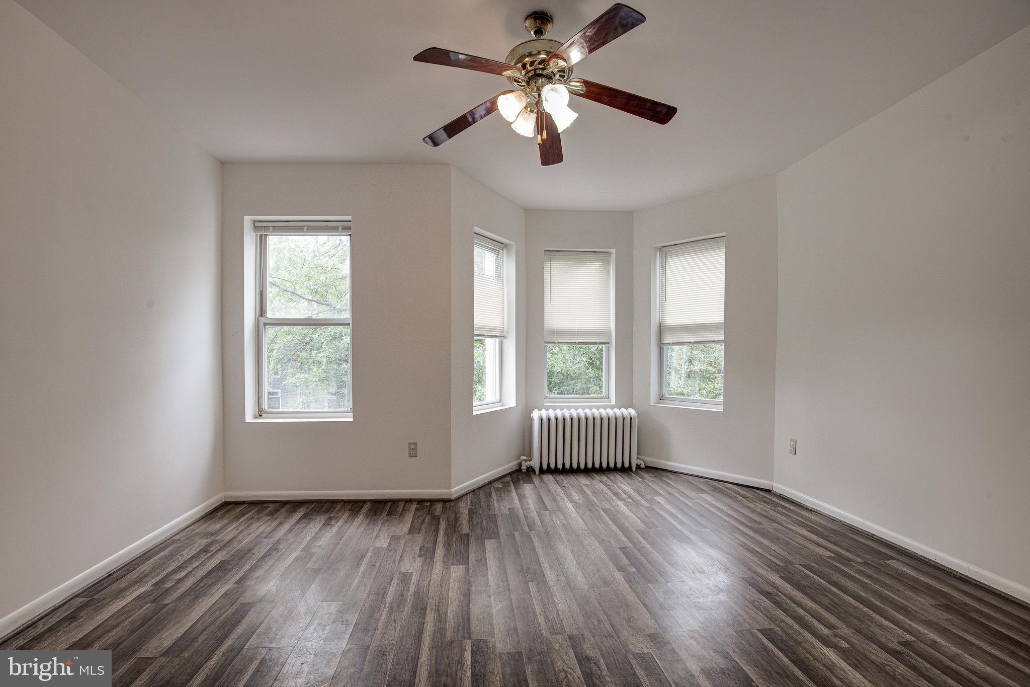 1528 E Street Southeast Washington, DC 20003 - Photo 24 of 30 a view of empty room with wooden floor and fan