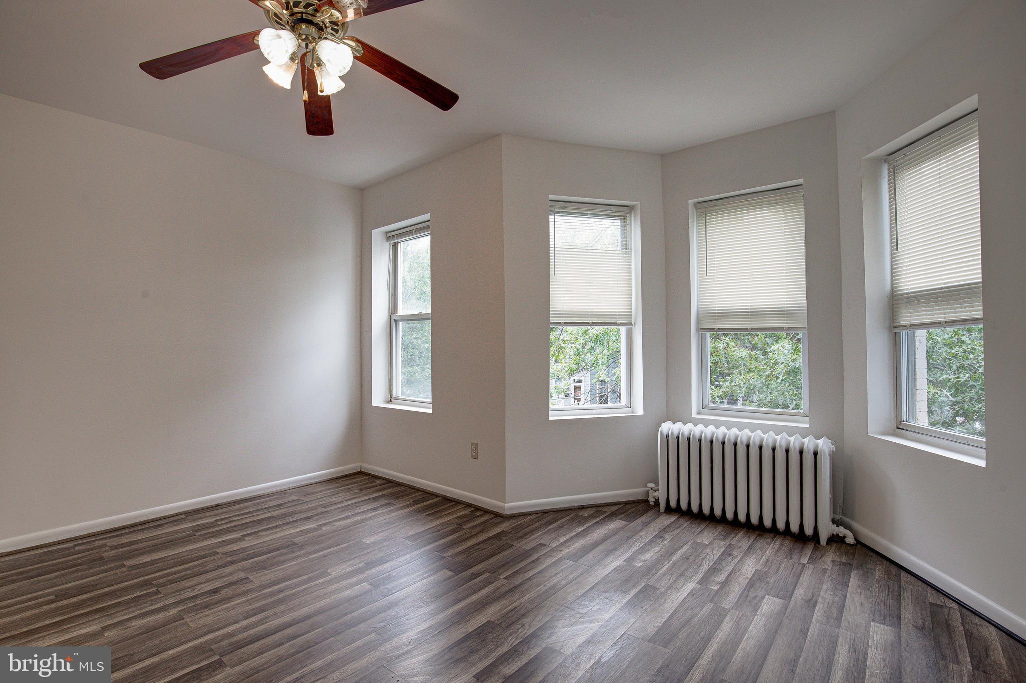 1528 E Street Southeast Washington, DC 20003 - Photo 27 of 30 a view of an empty room with wooden floor and a window