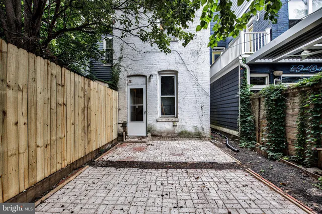 a view of a house with a door and a yard