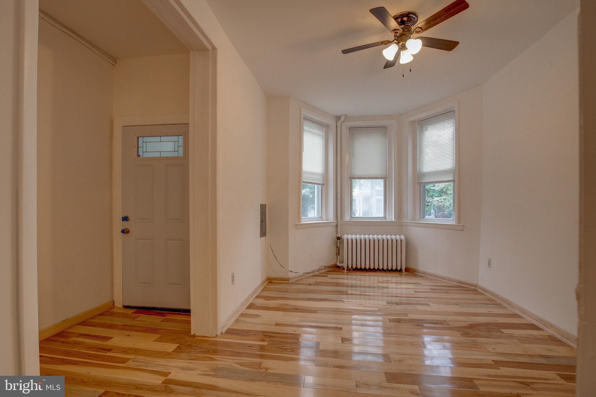 1528 E Street Southeast Washington, DC 20003 - Photo 7 of 30 a view of an empty room with wooden floor and a window