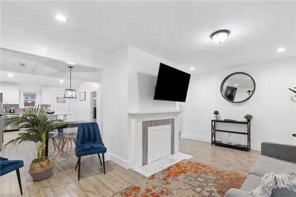 a open kitchen with white cabinets and stainless steel appliances