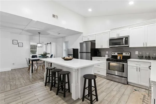 a kitchen with a sink a stove and refrigerator