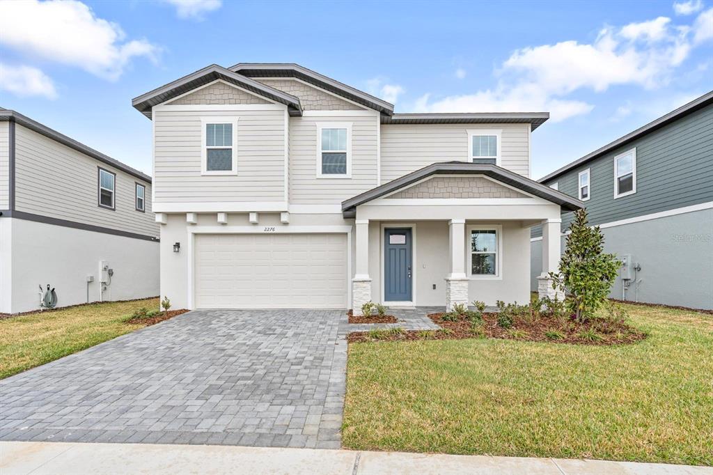2276 Hen Road Minneola, FL 34715 - Photo 1 of 40 a front view of a house with a yard