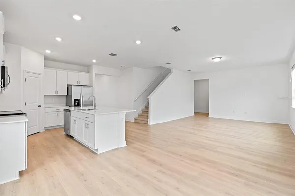a kitchen with white cabinets and stainless steel appliances