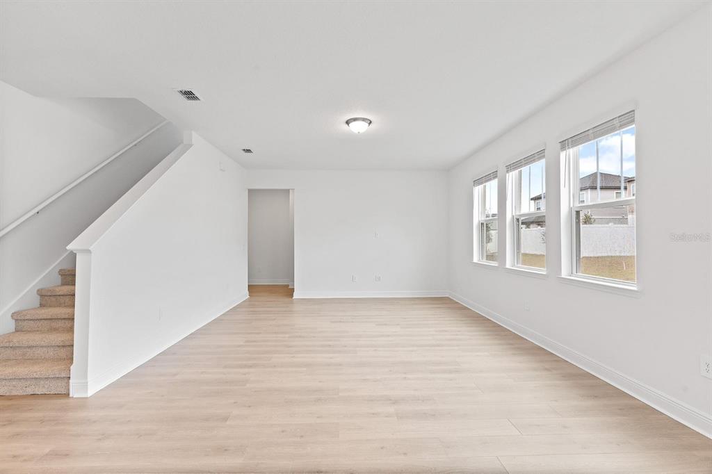 2276 Hen Road Minneola, FL 34715 - Photo 17 of 40 a view of an empty room with wooden floor and a window