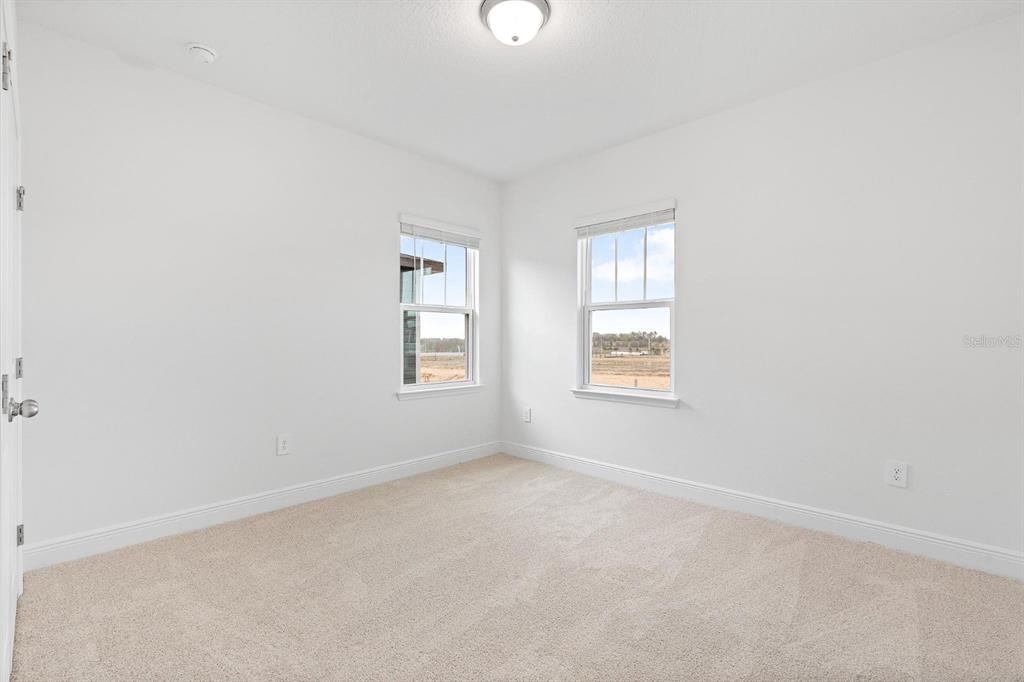 2276 Hen Road Minneola, FL 34715 - Photo 19 of 40 an empty room with windows