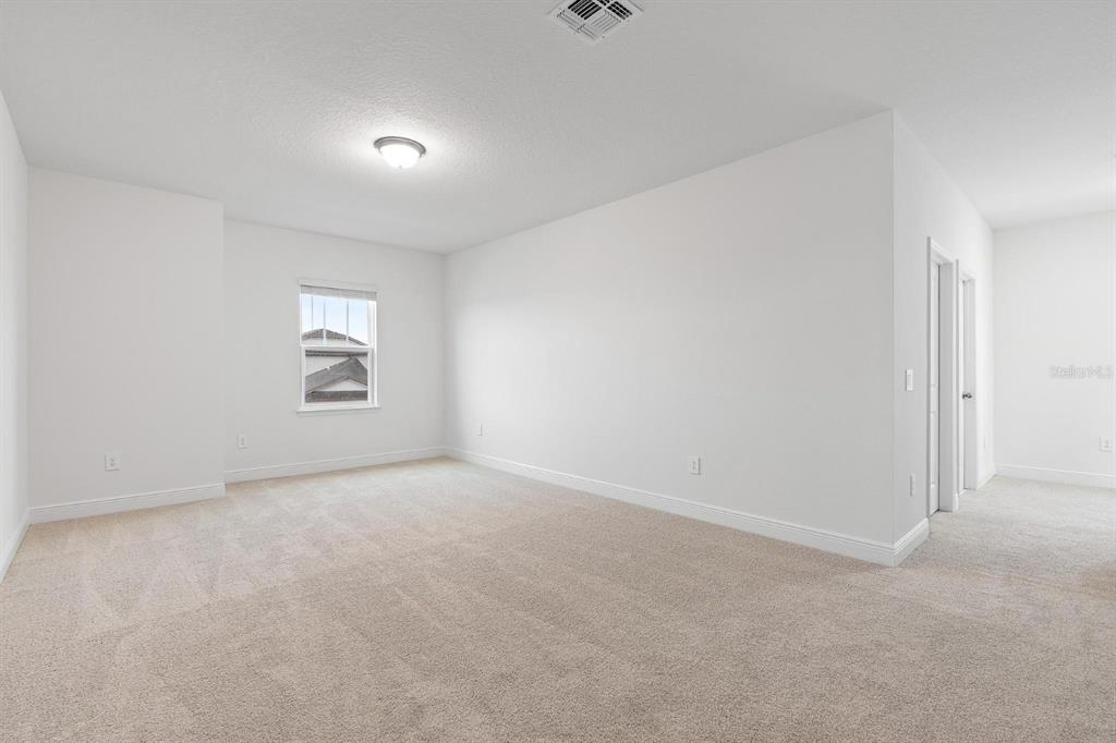 2276 Hen Road Minneola, FL 34715 - Photo 20 of 40 an empty room with windows
