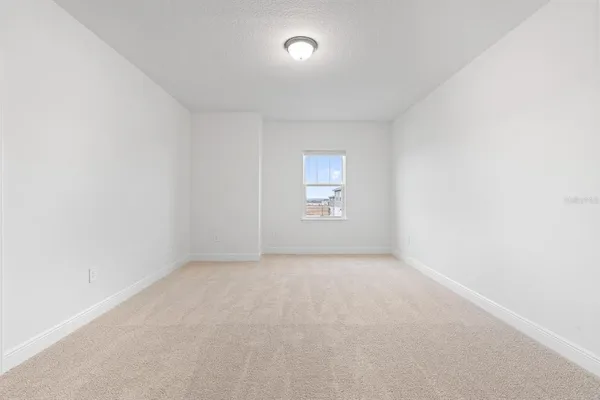 an empty room with a empty space and windows