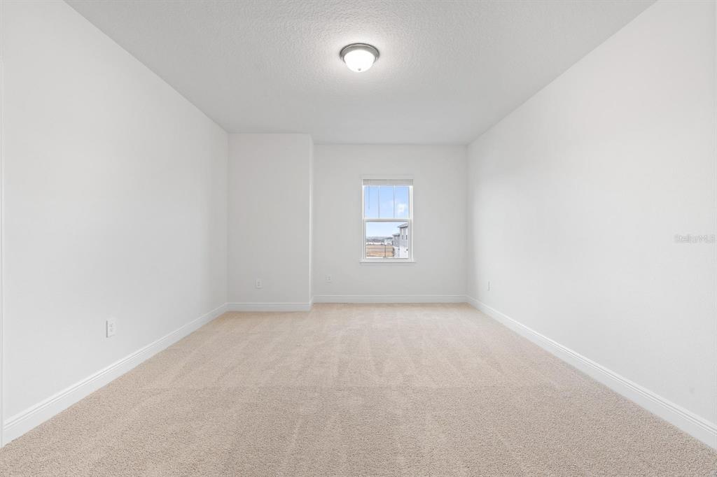 2276 Hen Road Minneola, FL 34715 - Photo 21 of 40 an empty room with a empty space and windows