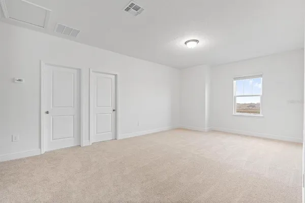 a view of an empty room and a window