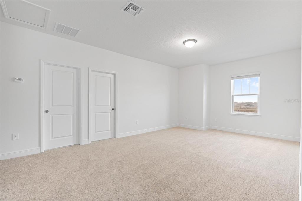 2276 Hen Road Minneola, FL 34715 - Photo 25 of 40 a view of an empty room and a window