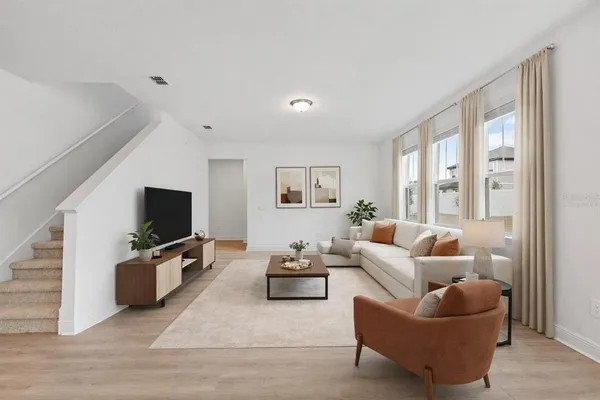 a living room with furniture and a flat screen tv