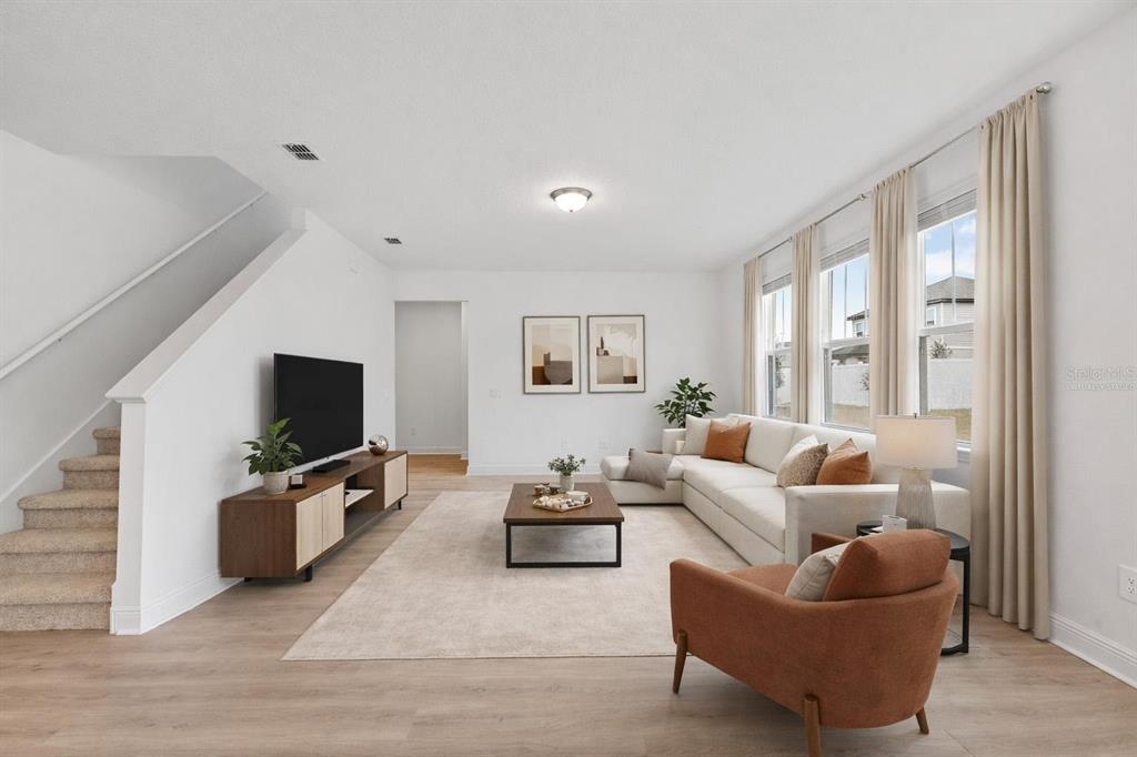 2276 Hen Road Minneola, FL 34715 - Photo 3 of 40 a living room with furniture and a flat screen tv