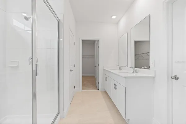 a bathroom with a double vanity sink and mirror