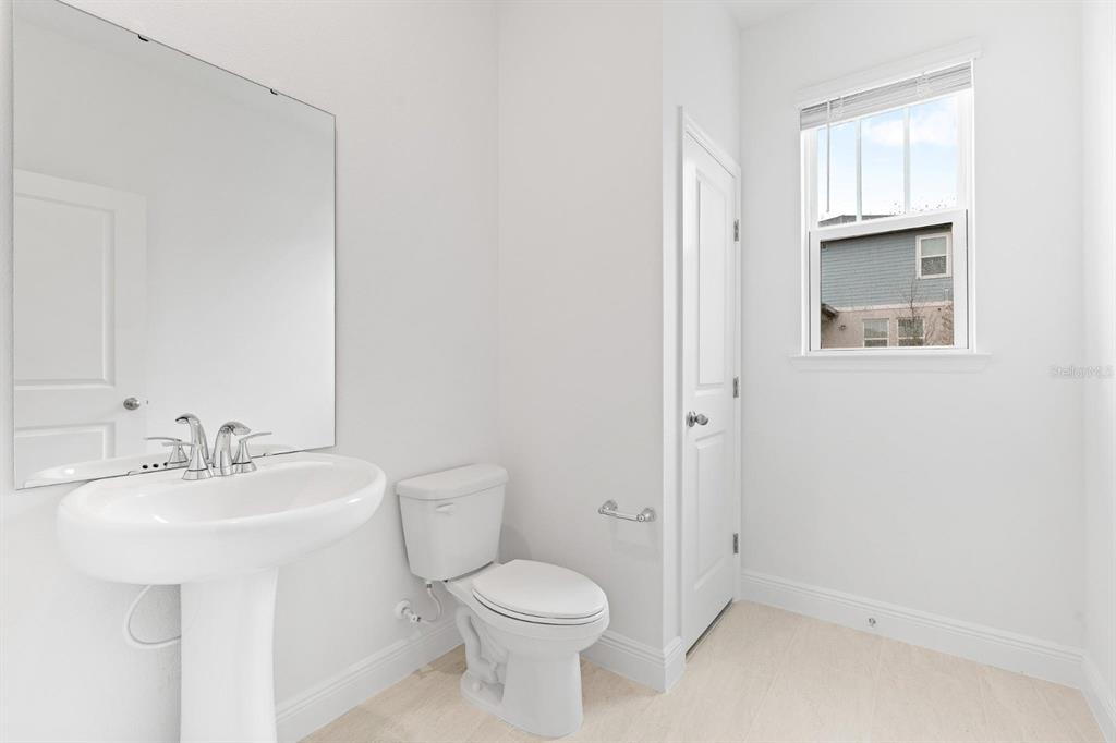 2276 Hen Road Minneola, FL 34715 - Photo 33 of 40 a bathroom with a sink toilet and vanity