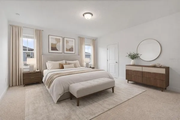a bedroom with a bed mirror and window