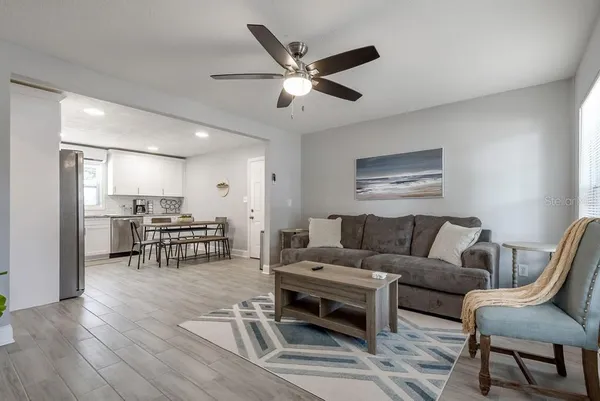 a living room with furniture and kitchen view