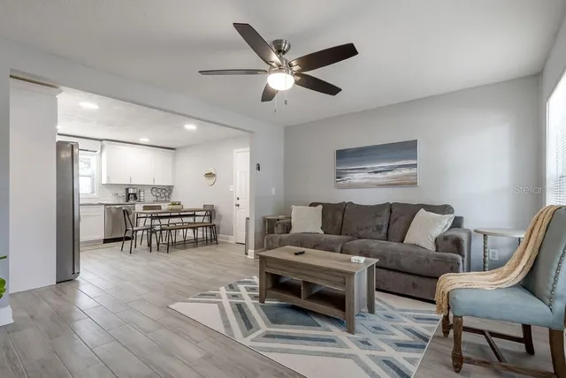 a living room with furniture and kitchen view
