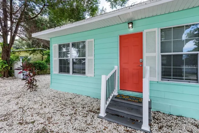 a front view of a house with a garden