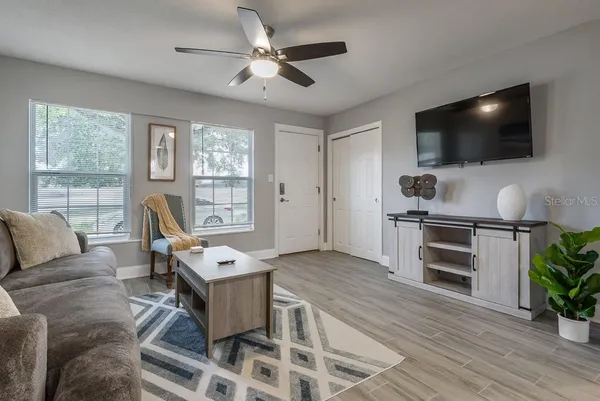 a living room with furniture and a flat screen tv