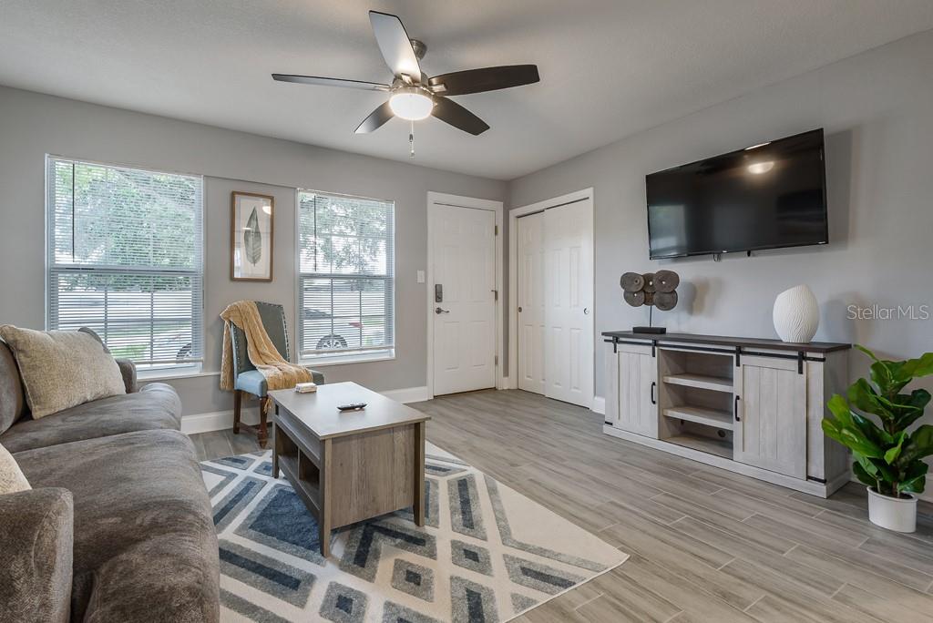 15732 Bolesta Road, Unit A Clearwater, FL 33760 - Photo 2 of 13 a living room with furniture and a flat screen tv