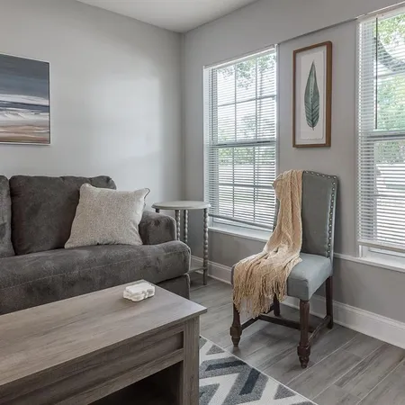 a living room with furniture and a window